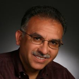 Training Series 1 A middle-aged man with short dark hair, glasses, and a mustache, wearing a maroon checkered shirt, smiles at the camera against a dark background—perfect for introducing your next Training Series.
