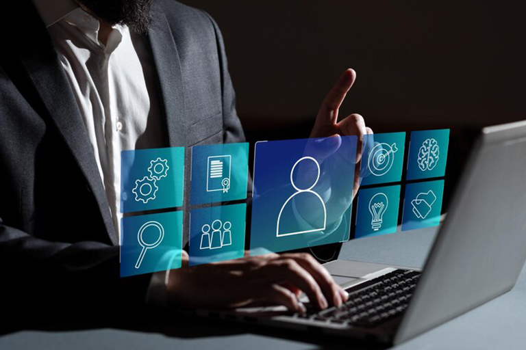 A person in a suit using a laptop, interacting with virtual icons representing user profile, search, market trends, documents, settings, teamwork, target, brain, and lightbulb.