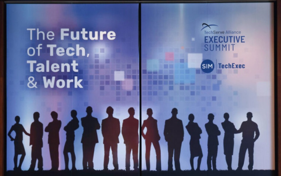 Leading Through Upheaval: Insights from the 2025 TechServe Executive Summit 1 A banner reads The Future of Tech, Talent, Market & Work with silhouettes of people standing in a row and logos for TechServe Alliance Executive Summit, SIM, and TechExec on a blue digital-themed background.