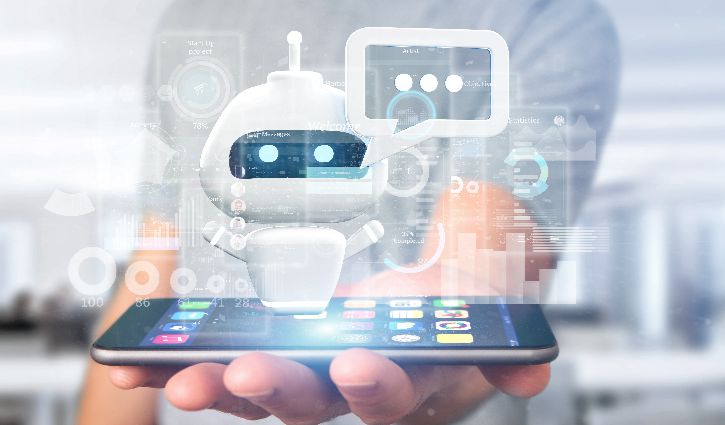 A person holds a smartphone with a floating digital chatbot hologram above it, featuring a robot icon and chat bubbles, symbolizing artificial intelligence and virtual assistant technology.