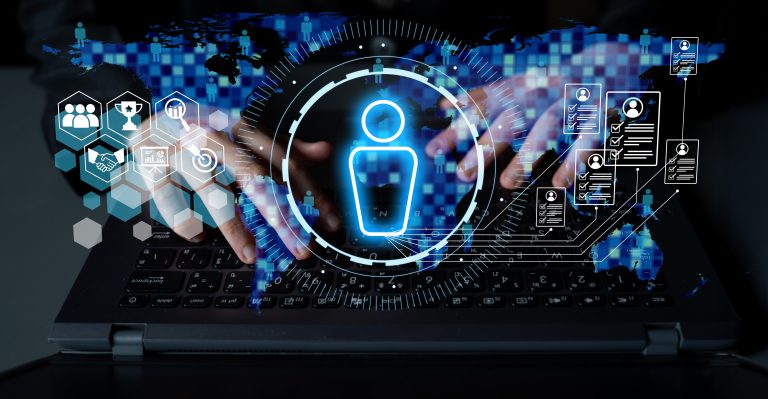 Hands typing on a laptop keyboard with digital icons overlaid, including a large user avatar, hexagons, and technological interface elements, suggesting themes of digital identity, AI integration, and cybersecurity.