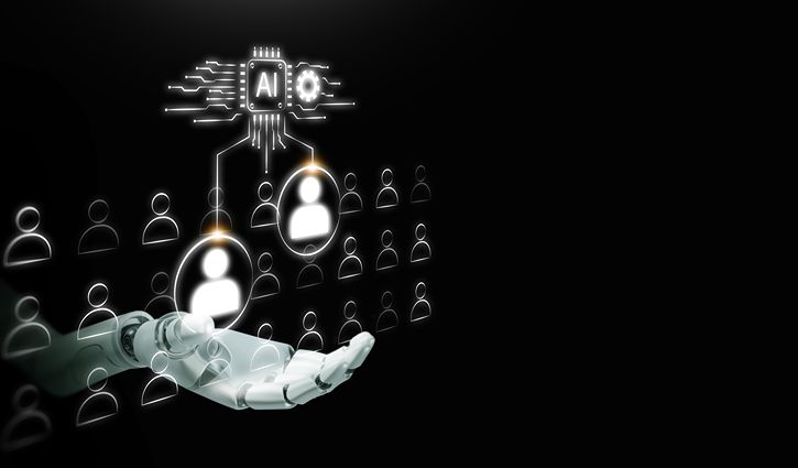 A robotic hand holds digital icons of people, with AI technology symbols above, representing the future of artificial intelligence managing or selecting individuals within the workforce in a network on a black background.