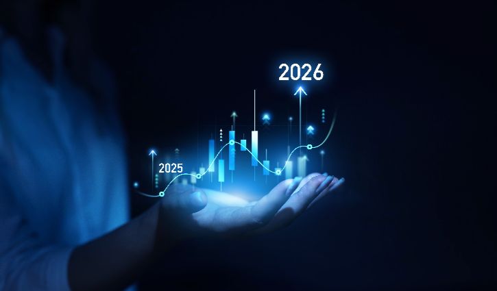 A hand holds a glowing graph with rising bars and trend lines labeled 2025 and 2026, symbolizing business growth, financial forecast, or future success.